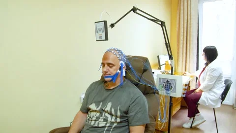A man undergoes an electroencephalogram (EEG) Видео 321609391