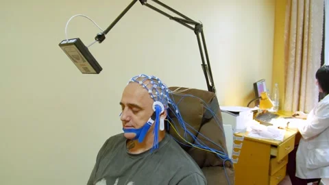 A man undergoes an electroencephalogram (EEG) Видео 321609397