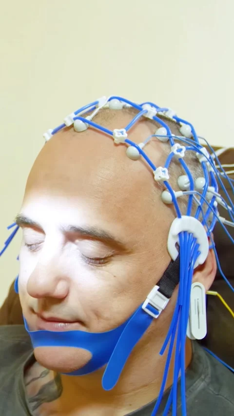 A man undergoes an electroencephalogram - vertical video Stock Footage 321799515