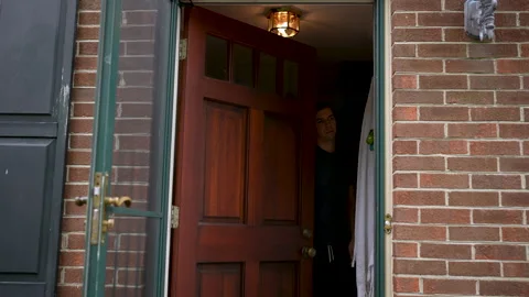 Man Unexpectedly Hit With Package Delivery Box As He Exits Home Stock Footage 160241440