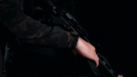 Man unfastens an empty magazine from his machine gun 動画素材 144068963