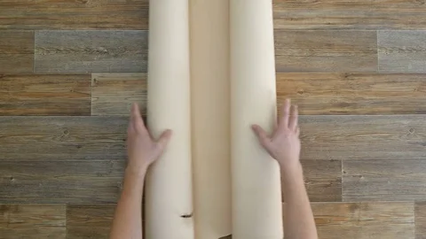 Man unfolds a light leather on a table and folds it 스톡 동영상 81420362