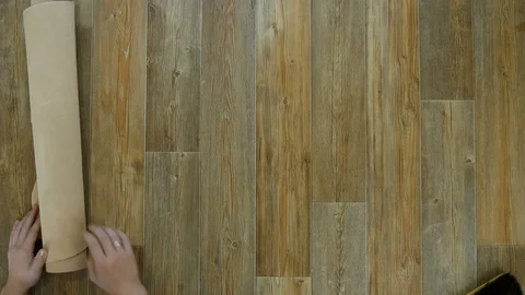 Man unfolds the light leather on the table and cleans it with a brush Video stock 81430786