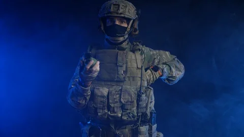 A man in uniform chooses between a grenade and an apple Stock Footage 118136883