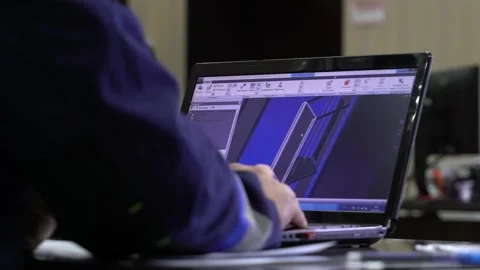 A man in uniform creates a model of a door in a computer program Stock Footage 220712983