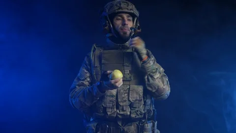 Man in uniform eating apples Stock Footage 118136946