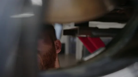 A man in uniform with a flashlight checks the brakes Stock Footage 221546036