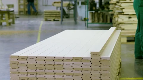 A man in a uniform working on a woodworking machine in a furniture factory. 4K 库存影片 163802358