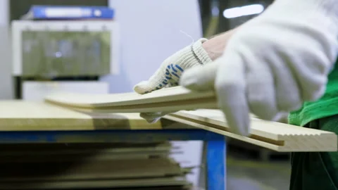 A man in a uniform works on a woodworking machine in a furniture factory. 4K Stock Footage 165239287