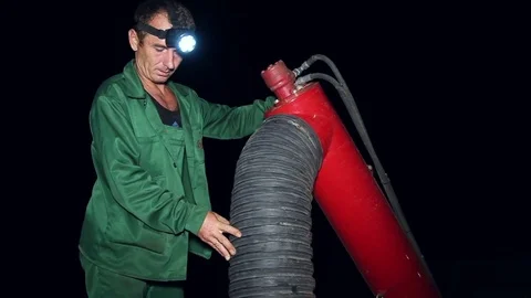 Man unload corn grain from the tractor trailer in silo Stock Footage 80437870