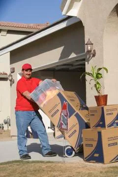 Man Unloading Boxes In Front Of New House Stock Photos
