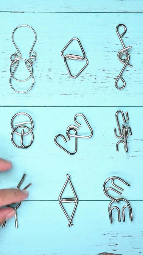 Man unlocking interlock steel hook puzzles vertical composition Stock Footage 218379167