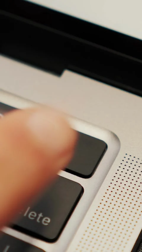 Man unlocking laptop computer with touch ID, close up of finger. Vertical video Stock Footage 311257898
