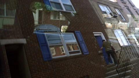 A man unlocks the door with a key and comes inside. Stock Footage 109599710