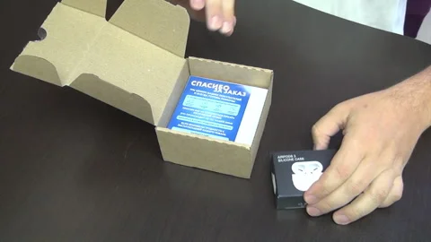 A man unpacked wireless headphones. Stock Footage 277114441