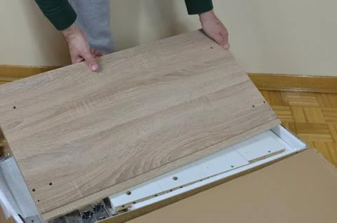 Man Unpacking Elements of Cabinet Stock Photos