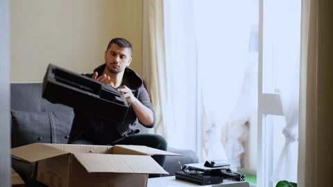 Man unpacking parcel with 3d printer at home 스톡 동영상 132808405