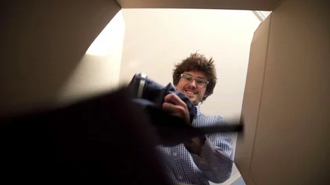 Man unpacking a parcel 動画素材 73184964