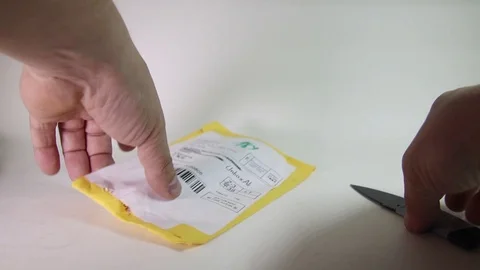 Man Unpacking Parcel Package From Abroad. Close-Up View. Stock Footage 96523582