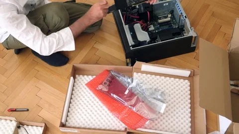 Man unpacking unboxing the Nvidia Quadro p4000 GPU Stock Footage 79244154