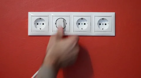 Man unplug and push electric plug into the socket Stock Footage 1050992