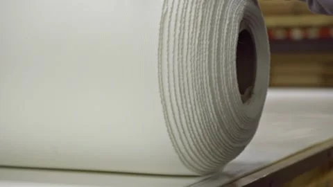Man Unrolling Fabric Material In A Factory. close up Stock Footage 149260016