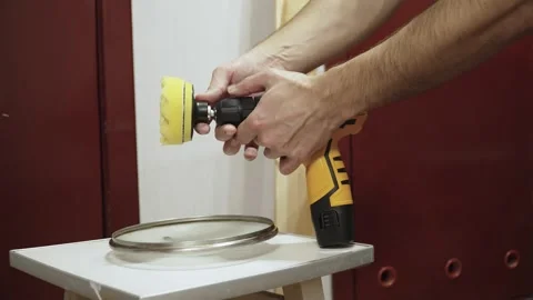 Man unscrewing chuck of screwdriver to replace polishing attachment closeup. Stock Footage 334339223