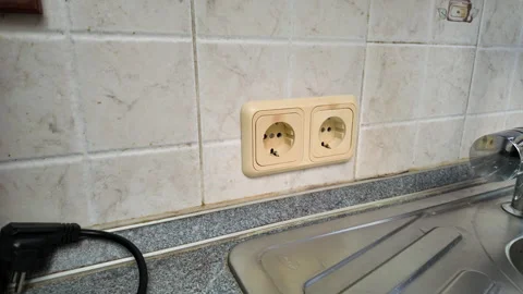 Man unscrewing an old wall socket to replace it Stock Footage 311983022