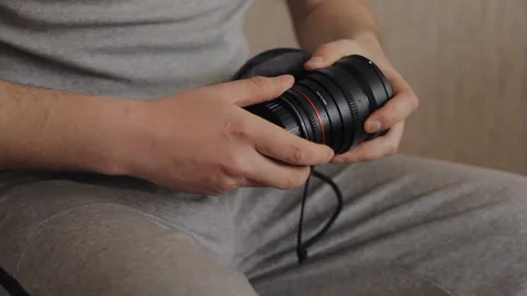 Man unscrews the back lens cap Stock Footage 136782897