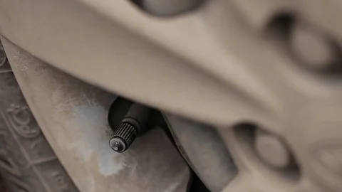 Man unscrews the cap on the bus and turns off the compressor Stock Footage 73605755