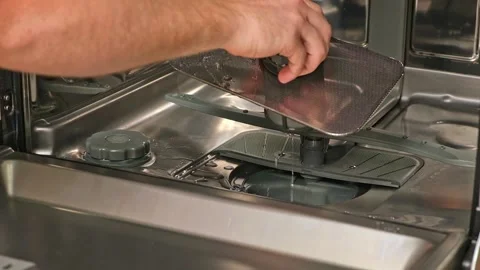 Man unscrews the filter for cleaning in dishwasher. Stock Footage 244804484