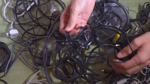 Man untangling tangled cables. Wireless concept. Closeup. Stock Footage 99918185