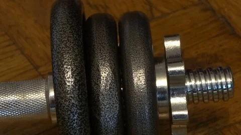Man untwists spin lock collar on the dumbbell. Stock Footage 70352921