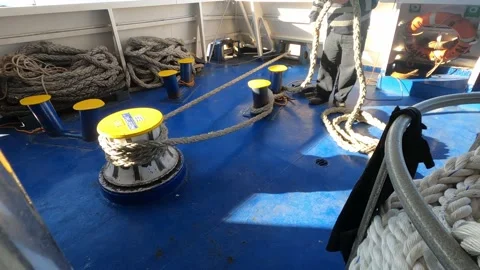 Man unwinds mooring cable. Stock Footage 230905101