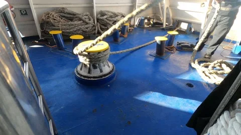Man unwinds mooring cable. Stock Footage 230905223