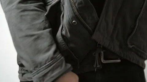Man Unzips Jacket and Pulls Handgun Out of Pants in Slow Motion Stock Footage 61271498