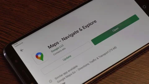A man updates a Google Maps application on his android smartphone. Close-up. Stock Footage 134450495