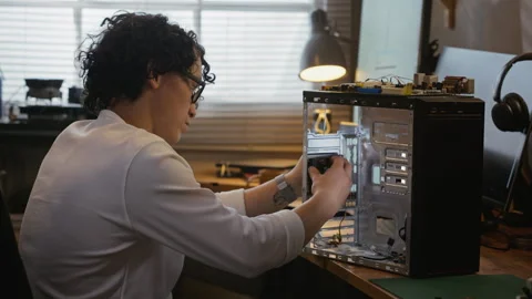 Man Upgrading Desktop Computer Hardware in Tech Workshop Stockbeeldmateriaal 338423053