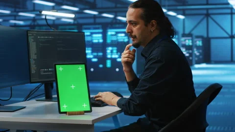 Man upgrading equipment in data center using isolated screen tablet Stock Footage 276139319