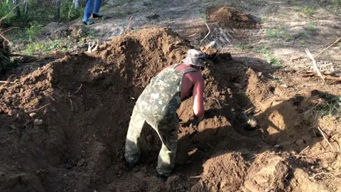 A man uproots old tree roots. 4K resolution Stock-Footage 130890935