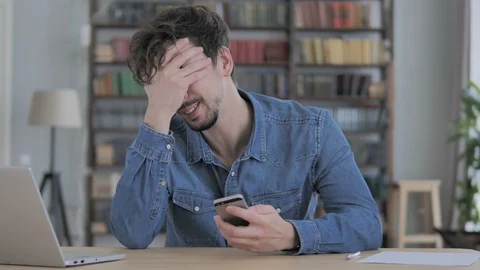 Man Upset for Loss while Using Smartphone Video stock 102025500