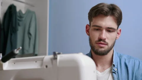 Man upset while sewing at home 스톡 동영상 244788167