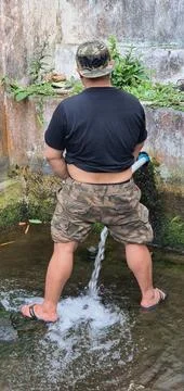 A man urinating in a river Stock Photos