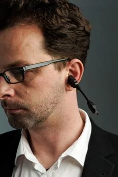 A man with a USB cable in his ear Stock Photos