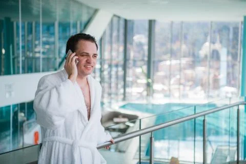 Man use the cellphone at luxury hotel spa in the near the swimming pool Stock Photos