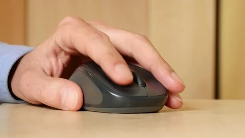 A Man use Computer Mouse clicking working on a Table - close-up Stock Footage 151634196