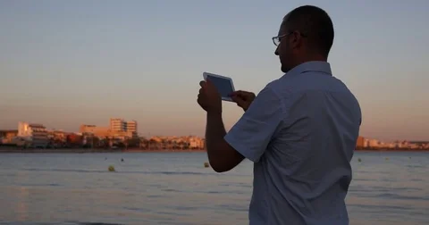 Man Use Digital Tablet Searching Environment Epic for Vacation near Coast Beach Video stock 77036953