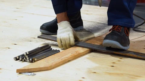 Man use grinder, saws rebars into small segments. Many sparks fly out, outdoor Stock Footage 126357034