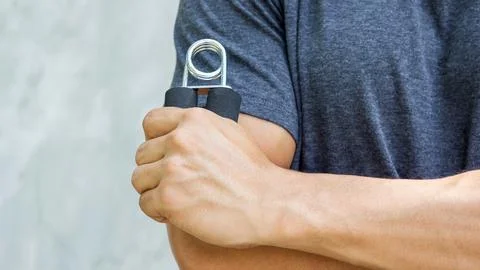 Man use handgrips for exercise. Stock Photos