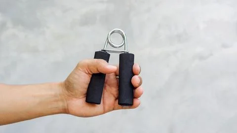 Man use handgrips for exercise. Stock Photos